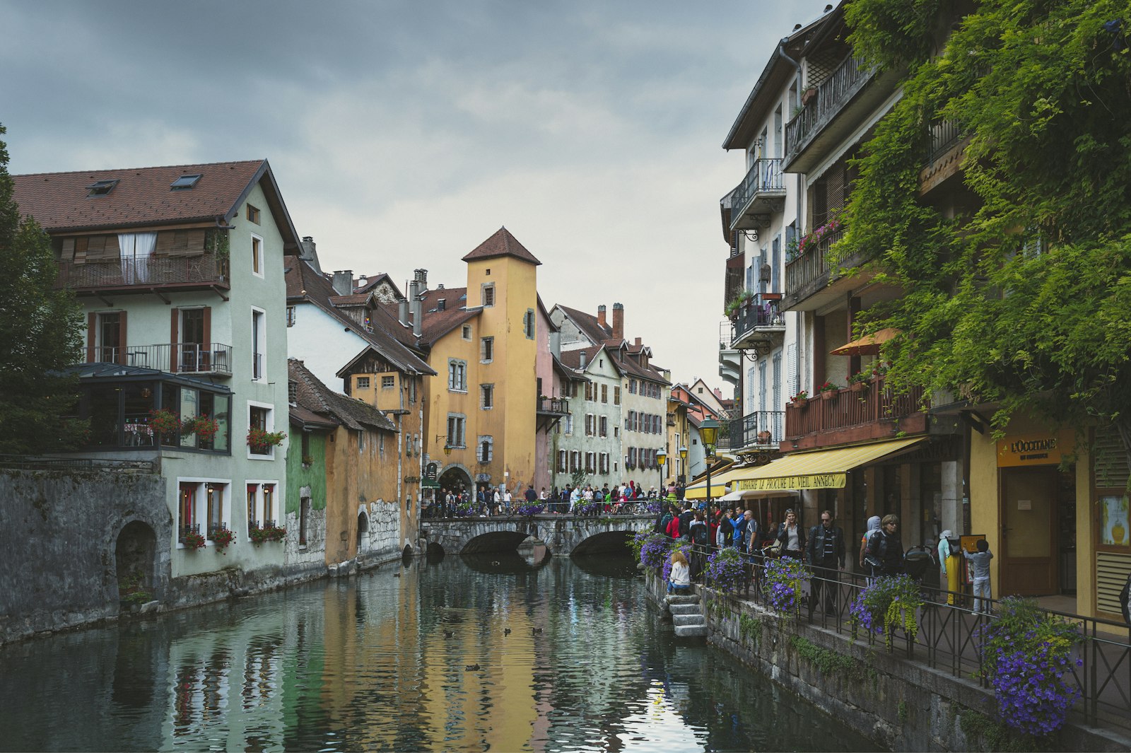 A river running between traditional buildings in an Alpine village