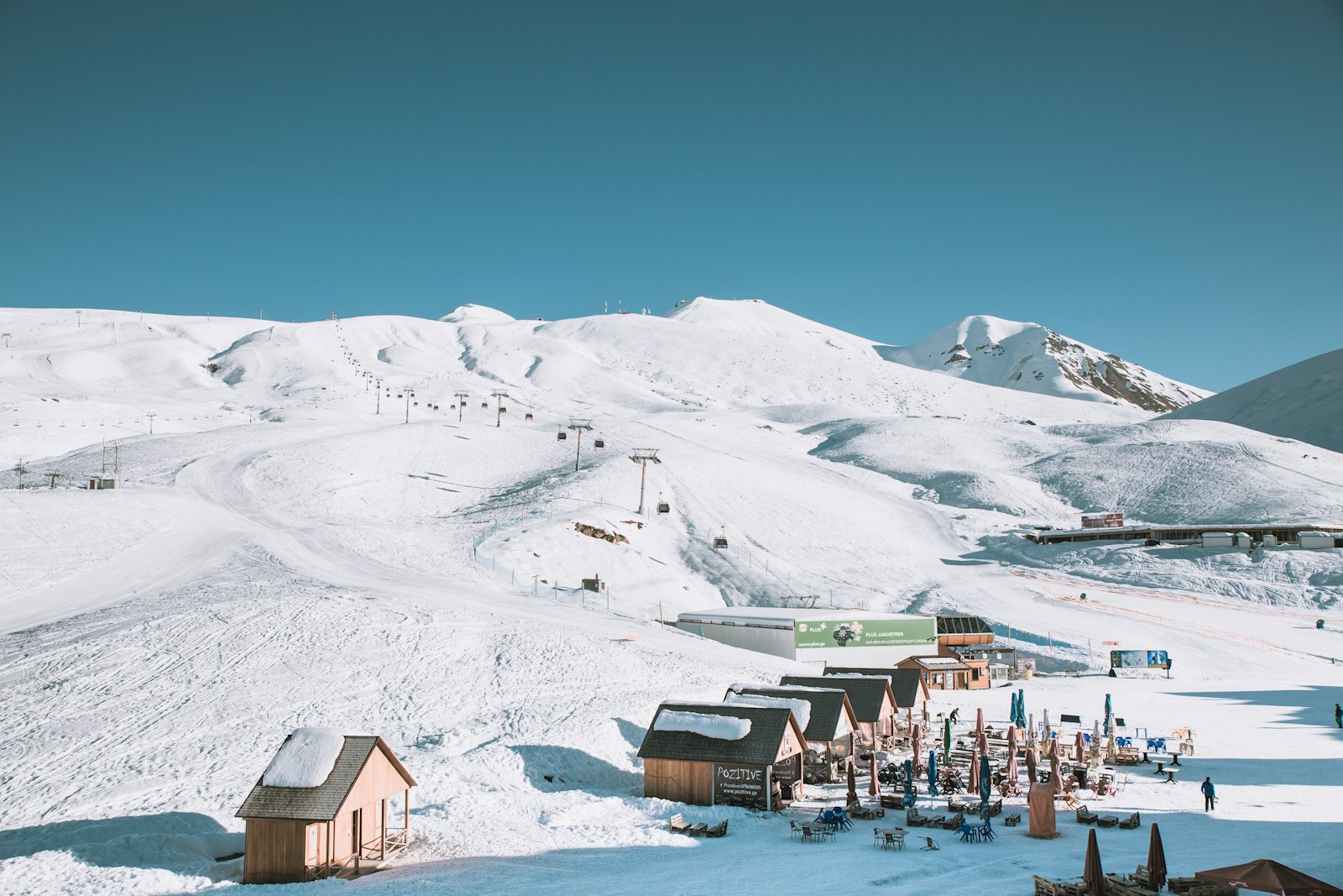 Chalet-style houses beneath a snow-covered Alpine mountain