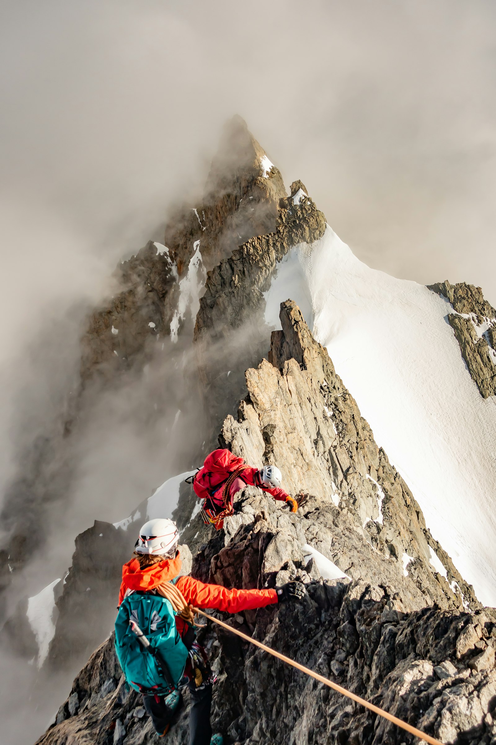 A climber on a snow-covered mountain ridge above Chamonix