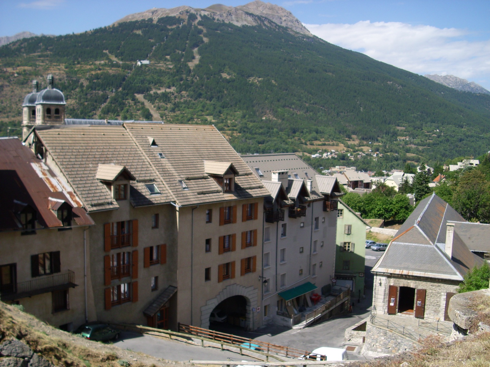The fortified old town of Briançon with the Serre Chevalier ski runs visible on the mountainside behind