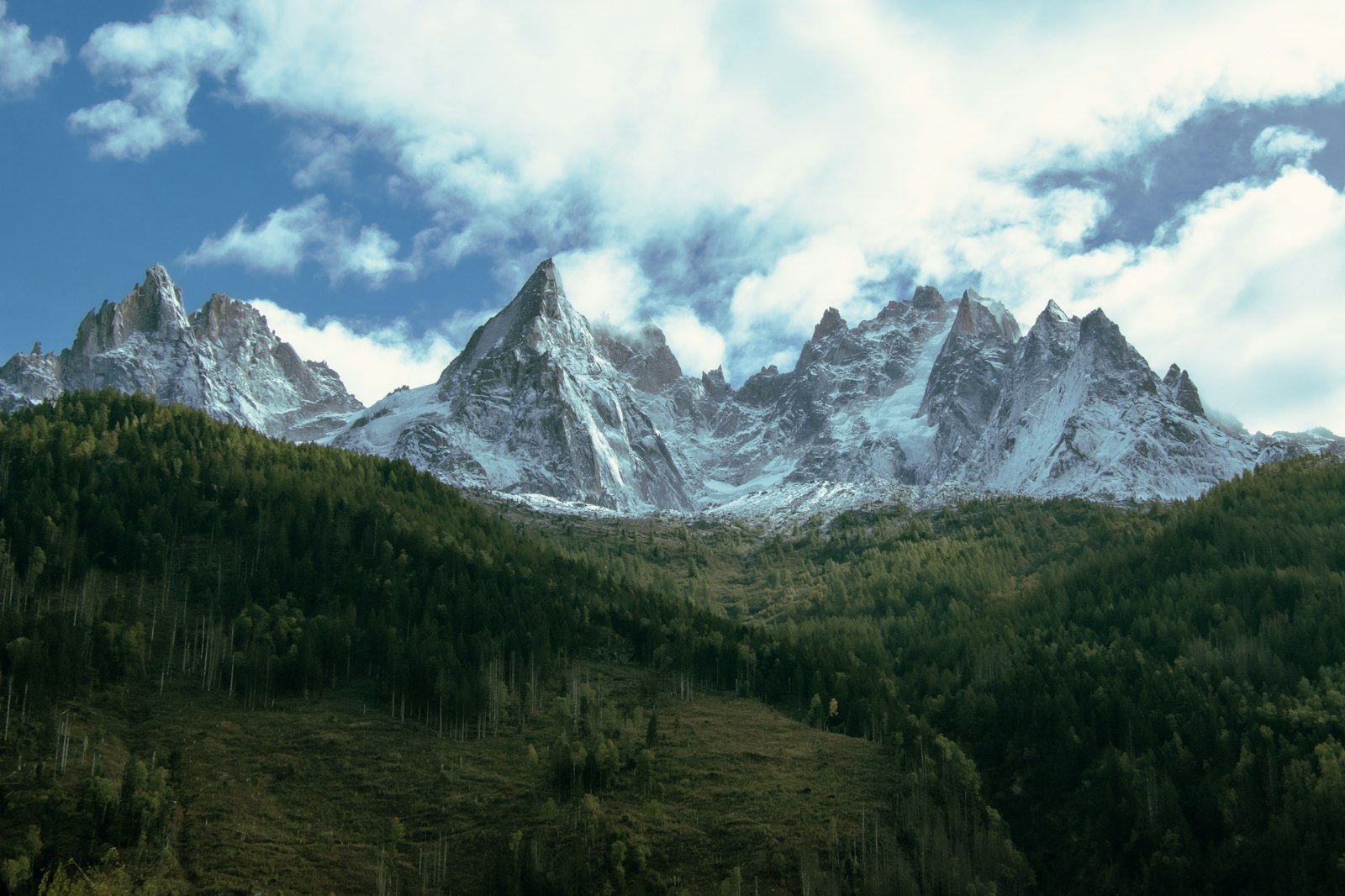 Dramatic snow-covered peaks of the Mont Blanc massif under a cloudy sky