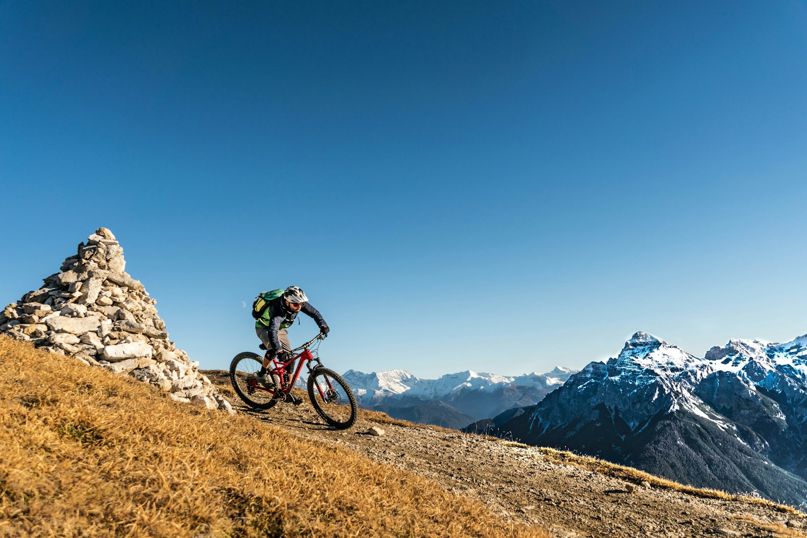 A mountain biker riding an alpine trail in summer