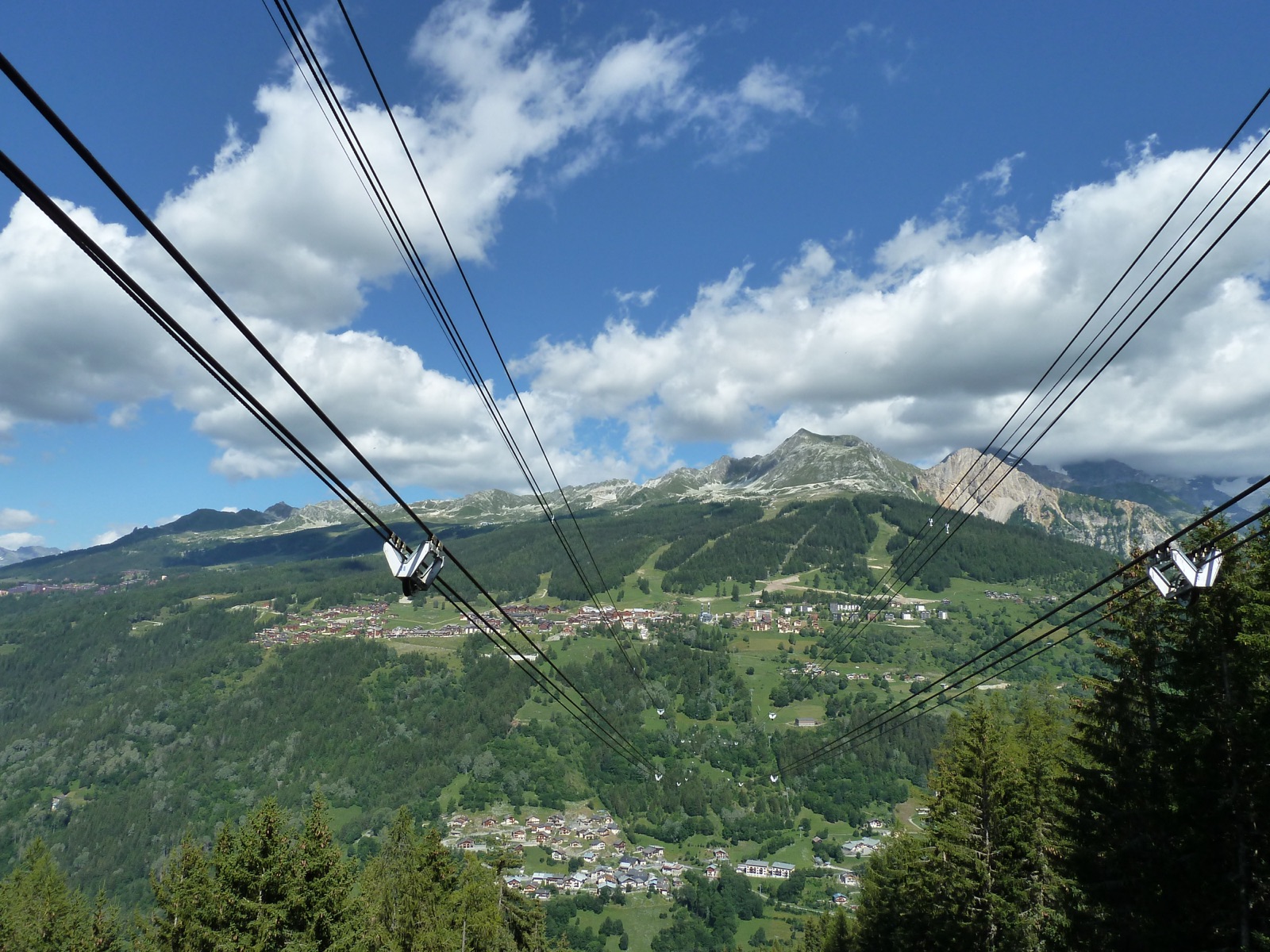 View from a Vanoise Express cable car cabin looking down over the wooded valley between Les Arcs and La Plagne